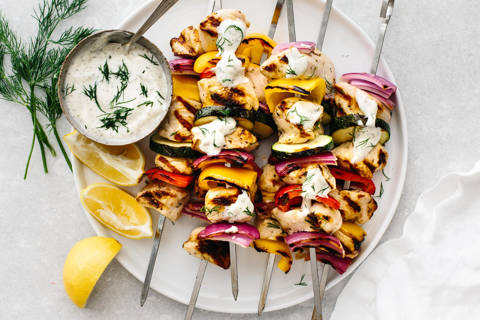 Greek chicken kabobs on skewers with red bell pepper and red onion, grilled golden