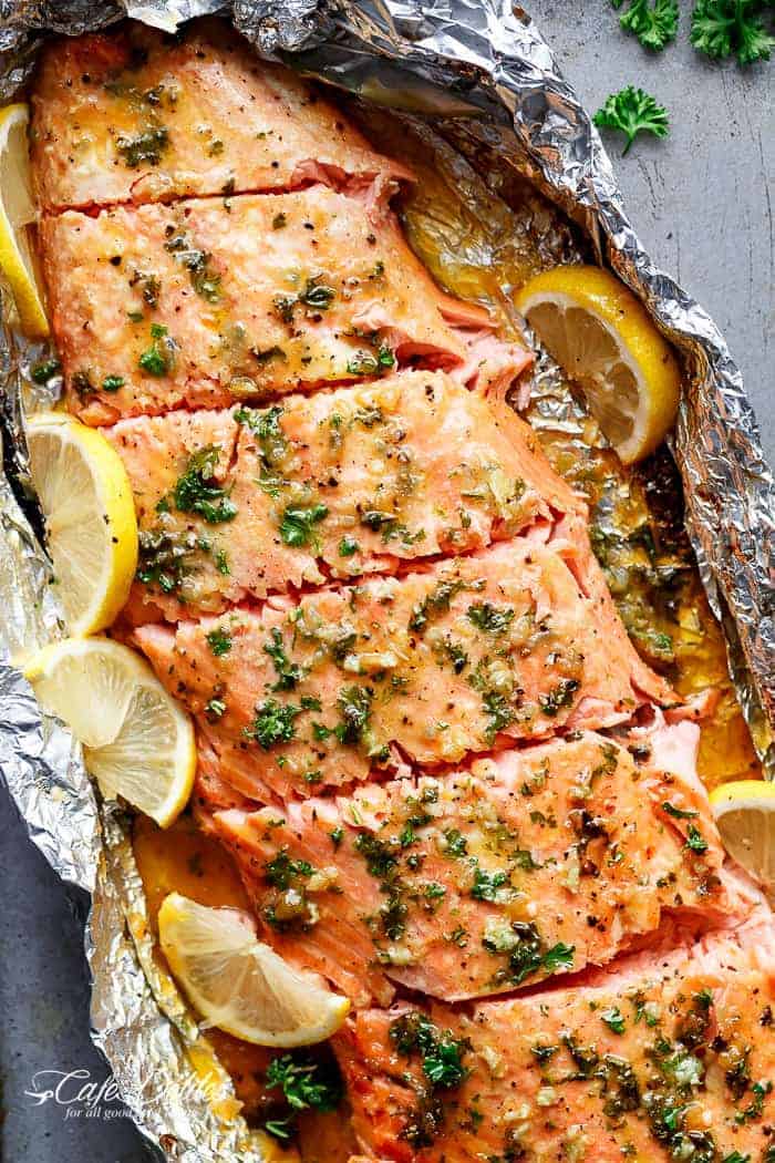 Honey garlic butter salmon baked in foil with lemon slices and fresh parsley