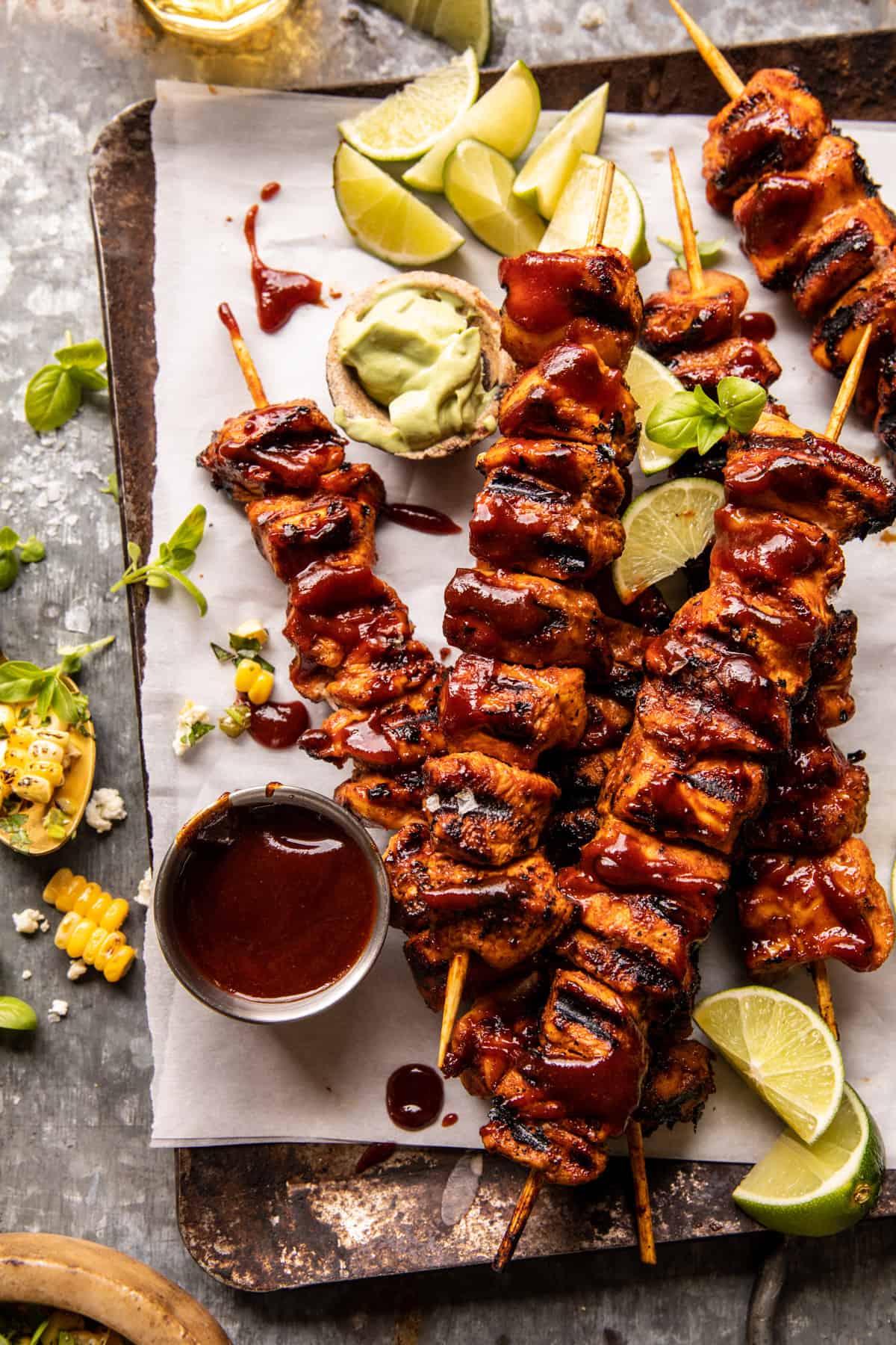 BBQ beer chicken skewers grilled with avocado corn and feta salsa on the side