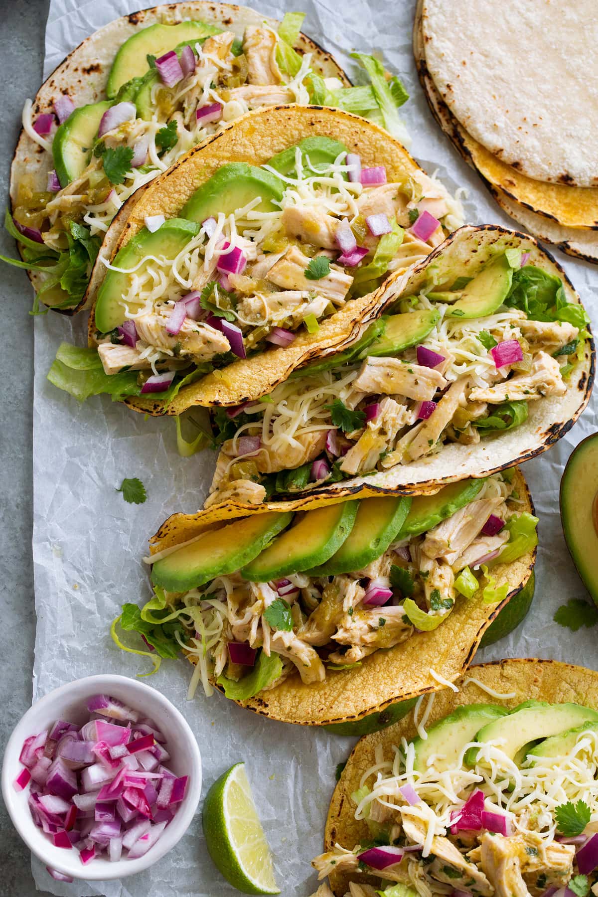 Salsa verde shredded chicken in soft tacos with lime and avocado