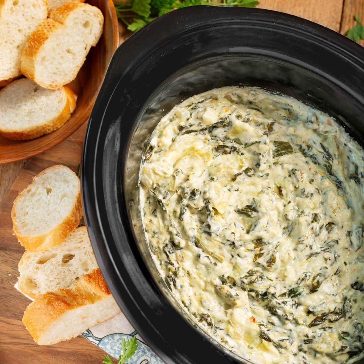 Slow Cooker Spinach Artichoke Dip warm and cheesy in crockpot