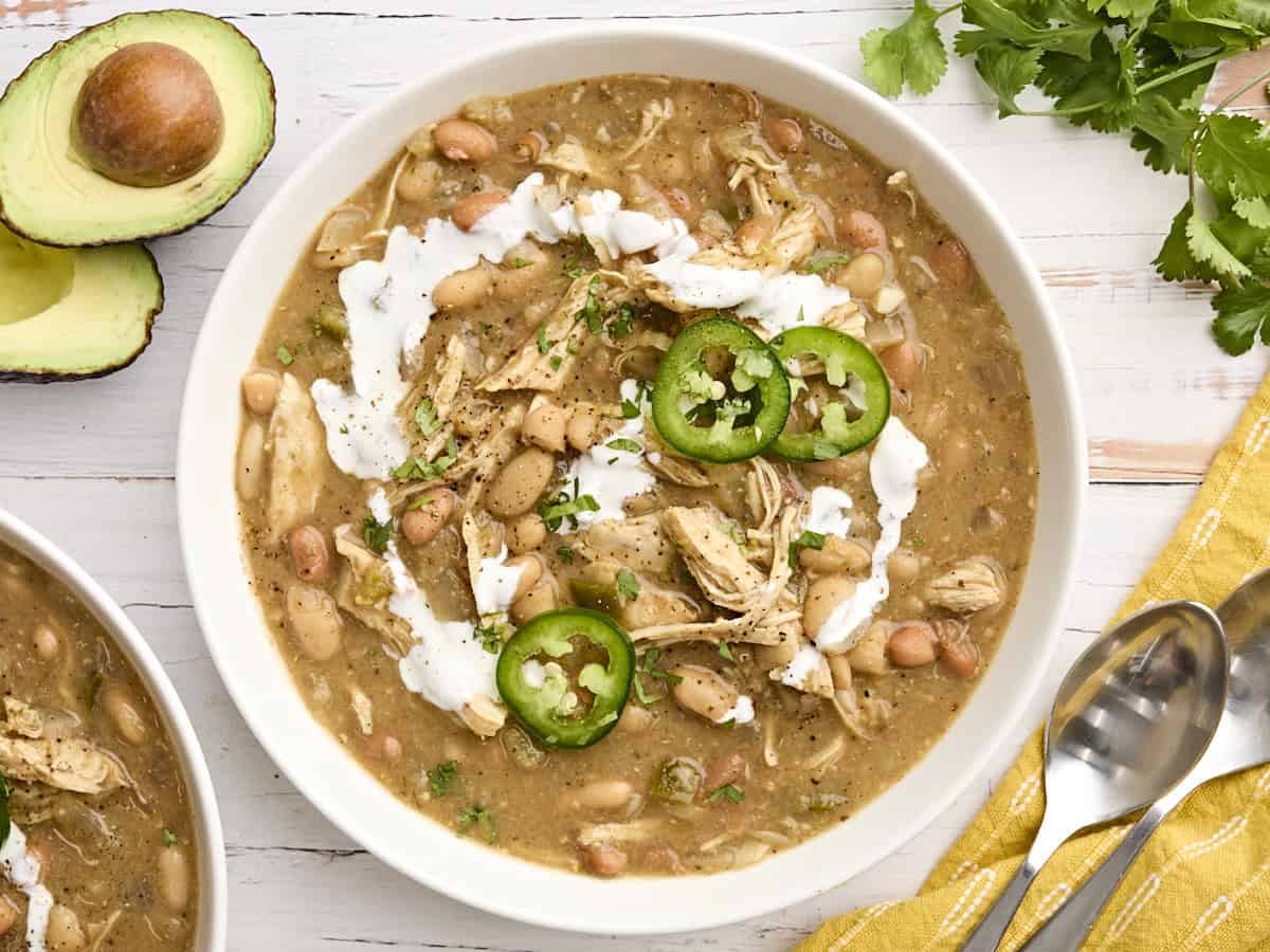 Easy Slow Cooker White Chicken Chili in a bowl with garnish