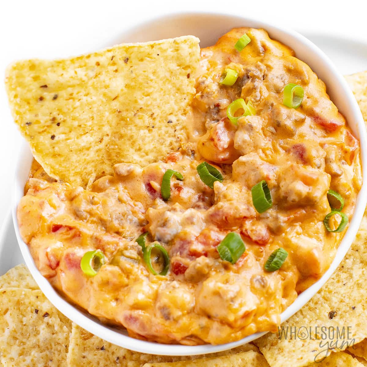 Sausage Rotel Dip cheesy with green onion garnish